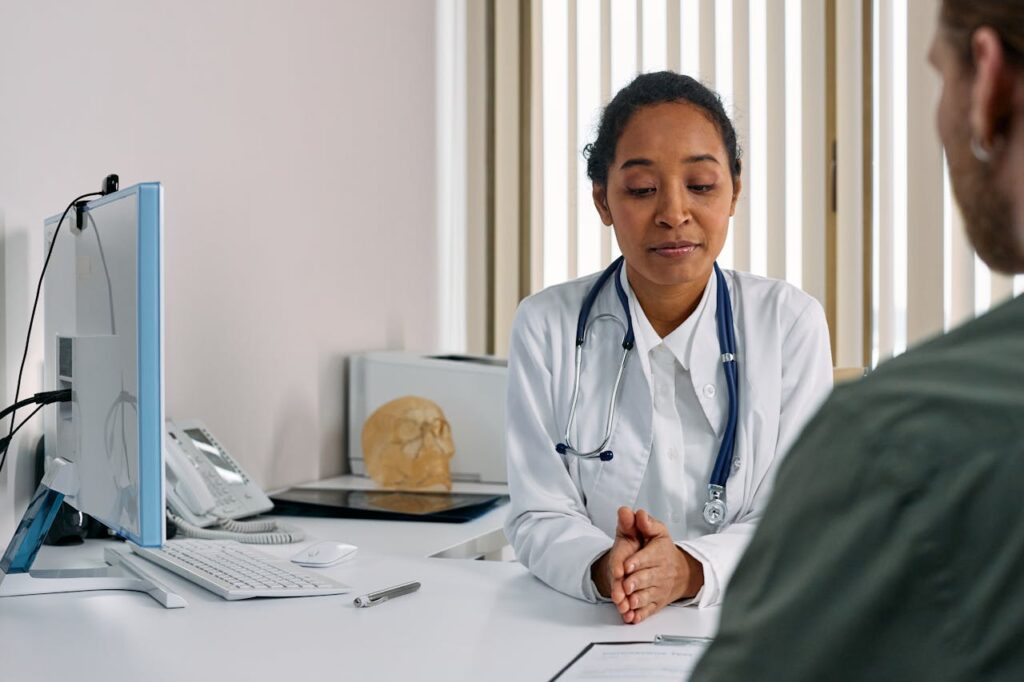 Registered general practitioner helping patient in clinic - Worthy Health