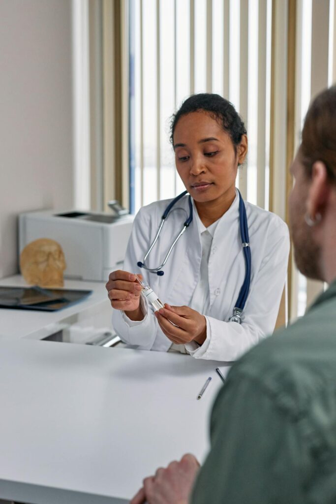 Registered general practitioner helping patient in clinic